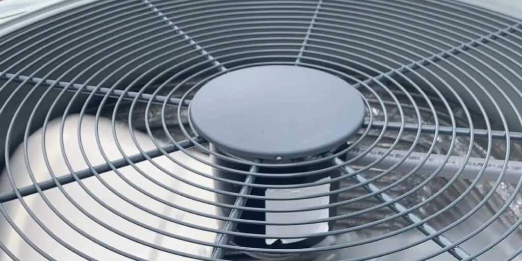 HVAC technician from SS&B Heating & Cooling replacing an air conditioner fan motor in Springfield, MO