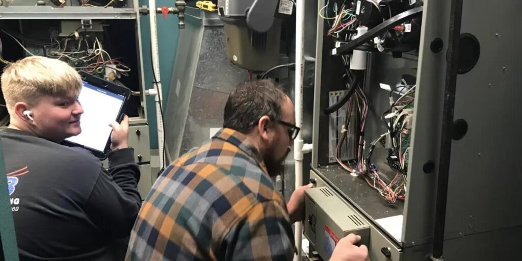 SS&B Heating & Cooling technician servicing a furnace in Springfield, MO.