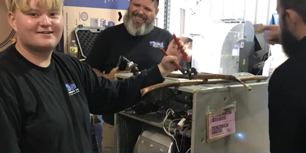 SS&B Heating & Cooling technicians servicing an older furnace in Springfield, MO.