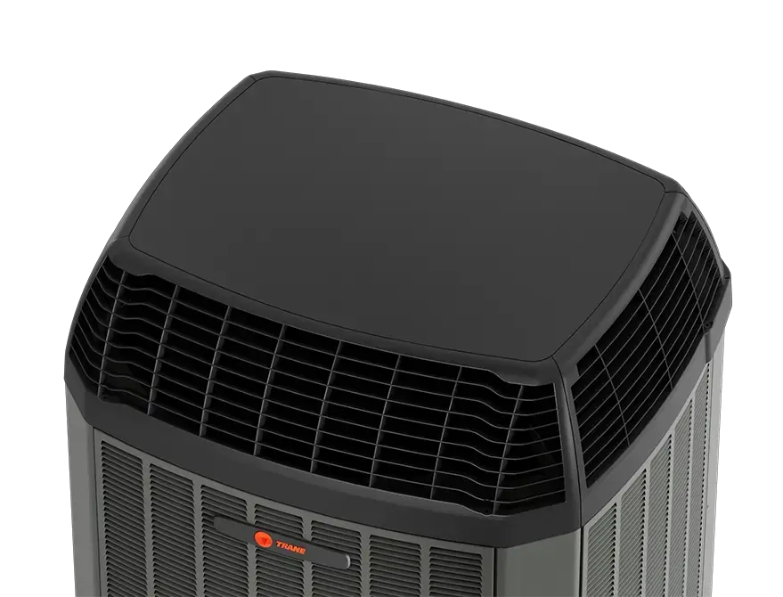 Trane WeatherGuard™ Top accessory installed on an outdoor air conditioner unit, designed to protect the fan and internal components from debris, weather, and sun exposure.